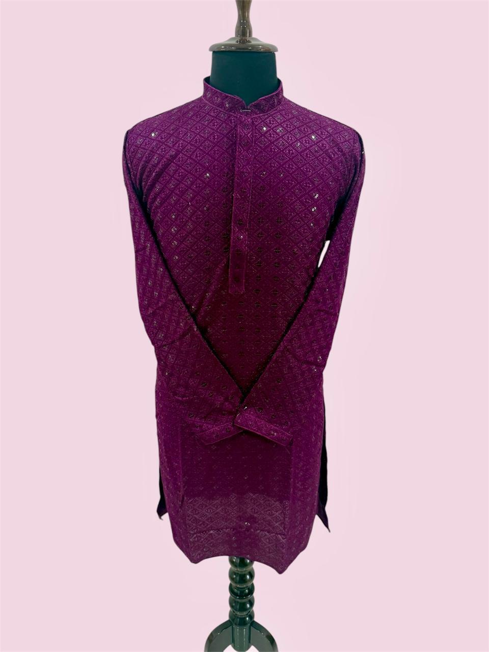 Purple textured garment on a mannequin against a light pink background