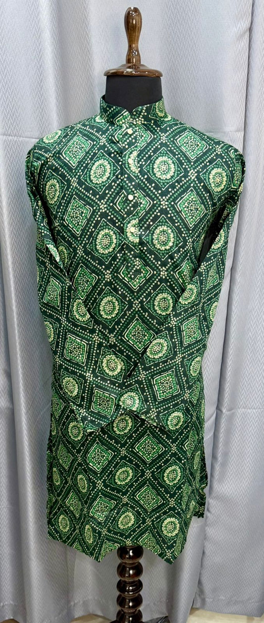 Green patterned dress on a mannequin against a white curtain background