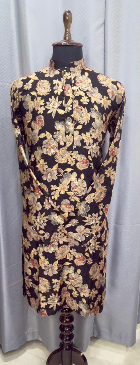 Floral black kurta on a mannequin against a gray curtain background