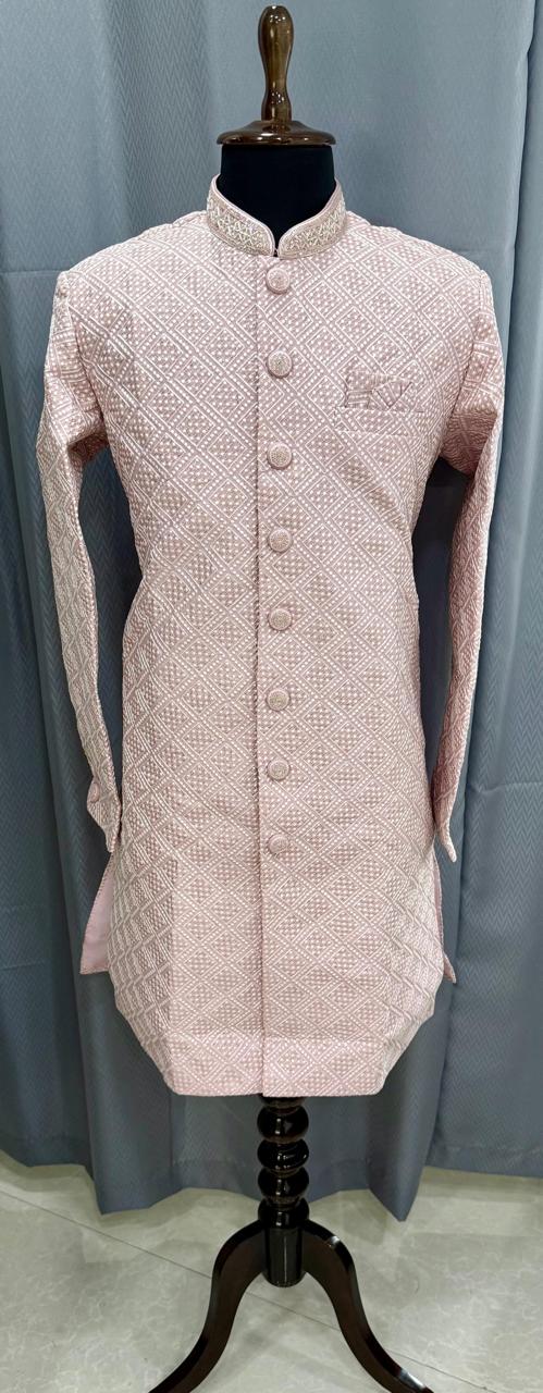 Pink embroidered sherwani on a mannequin against a gray background