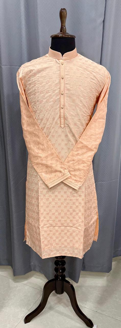 Peach pink kurta on a mannequin against a gray background