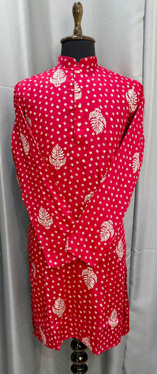 Red dress with white floral pattern on a mannequin against a gray background