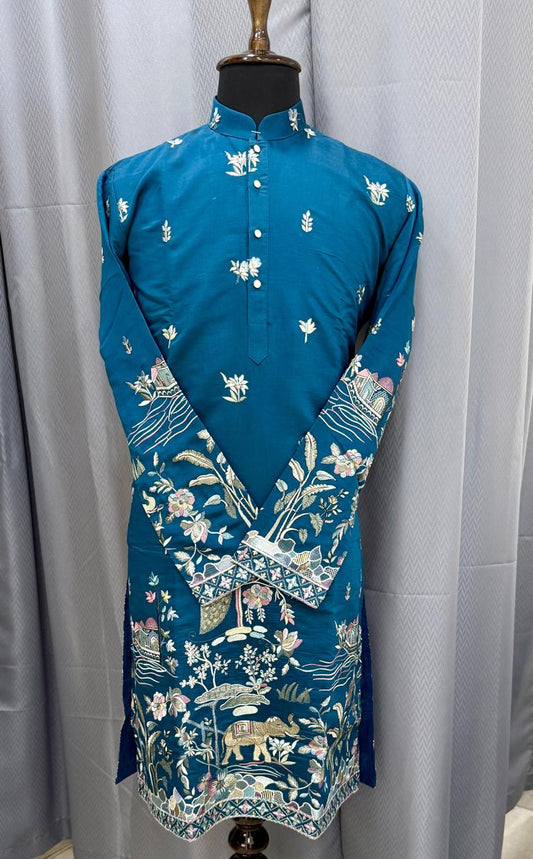 Blue kurta with floral patterns on a mannequin against a gray curtain background