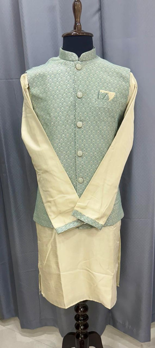 Mannequin wearing a traditional outfit with a green vest and beige kurta against a gray background