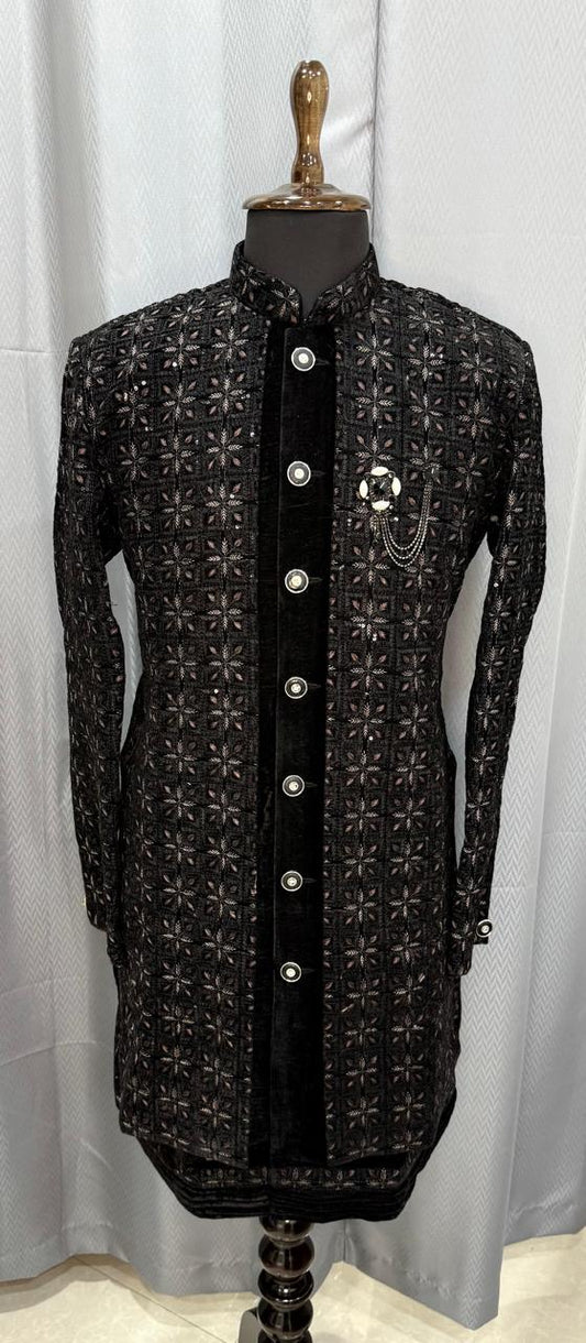 Black embroidered sherwani on a mannequin against a white background