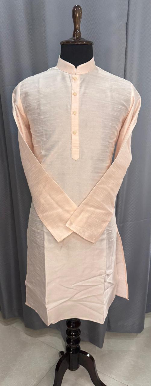 Mannequin wearing a light pink mens kurta against a gray curtain background