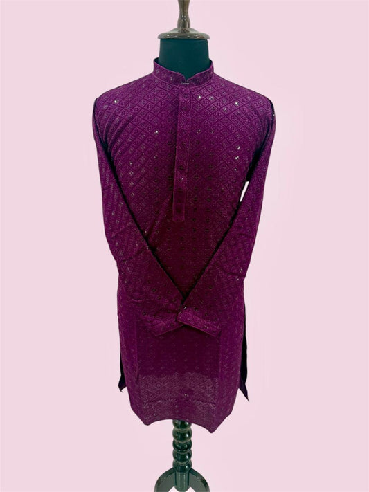 Purple textured garment on a mannequin against a light pink background